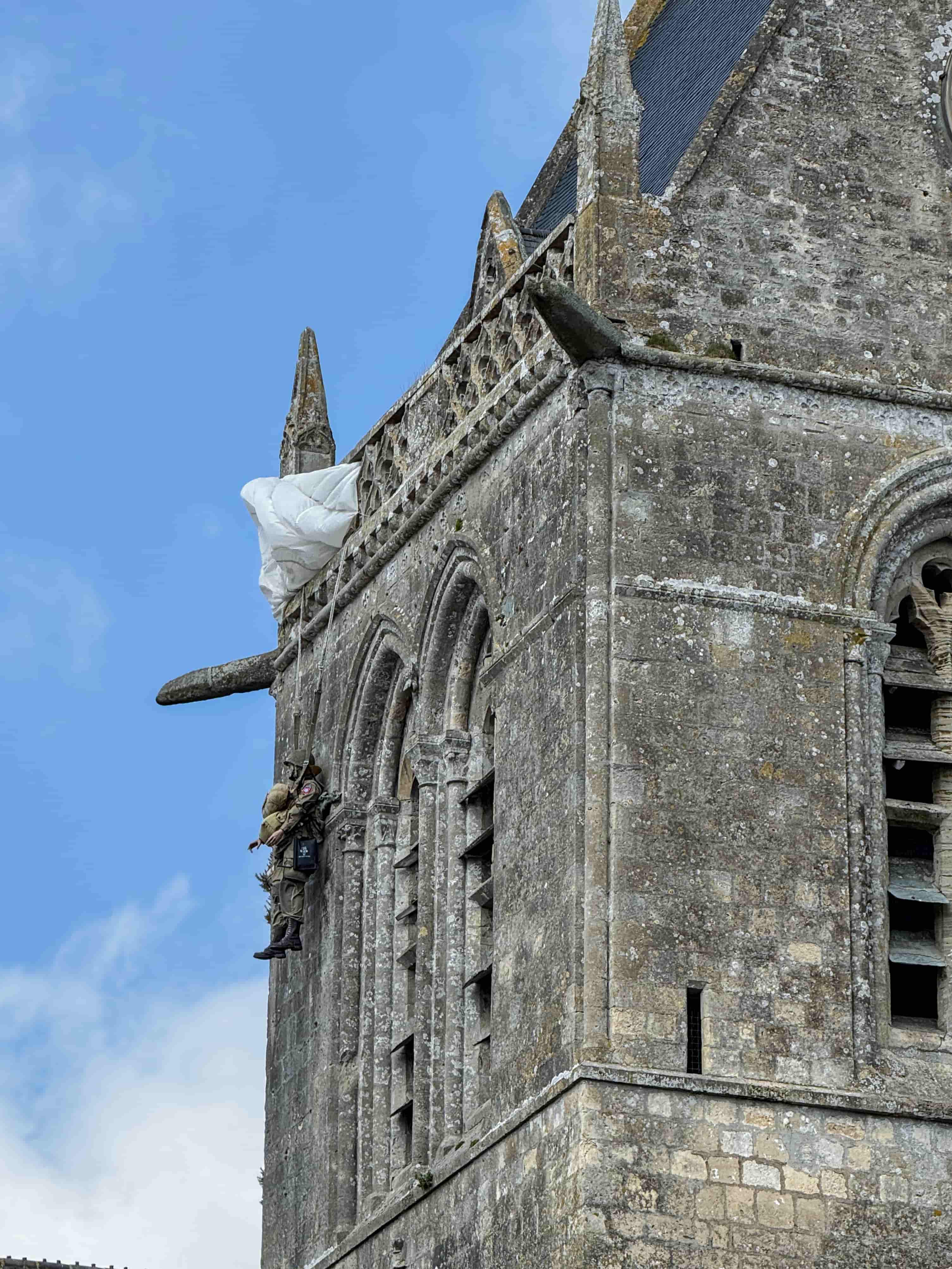 Paratrooper effigy on the Sainte-Mere-Eglise church steeple, an iconic D-Day site in Normandy