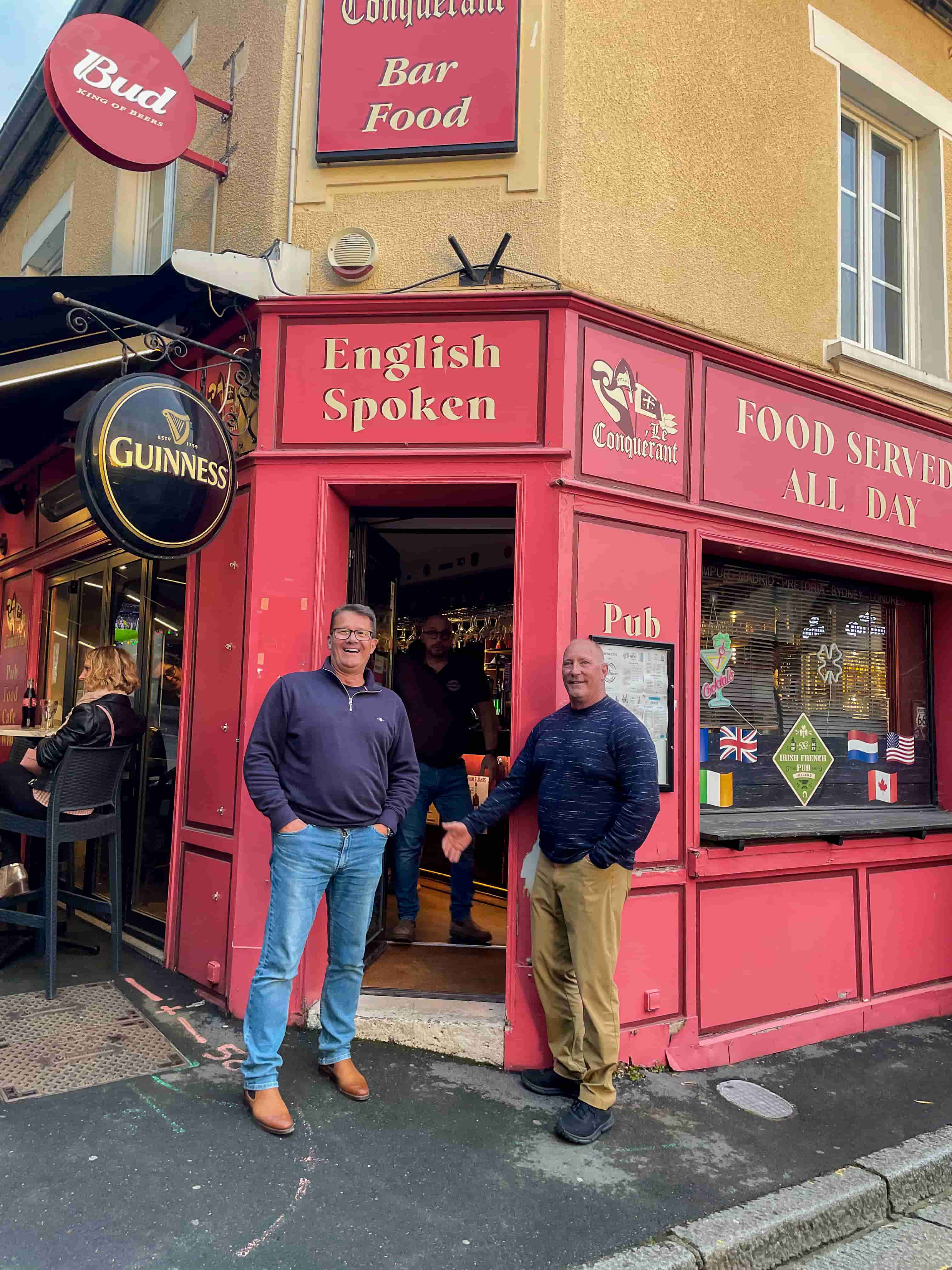 Two travelers outside a local Normandy pub on a Beyond the Beachhead D-Day tour