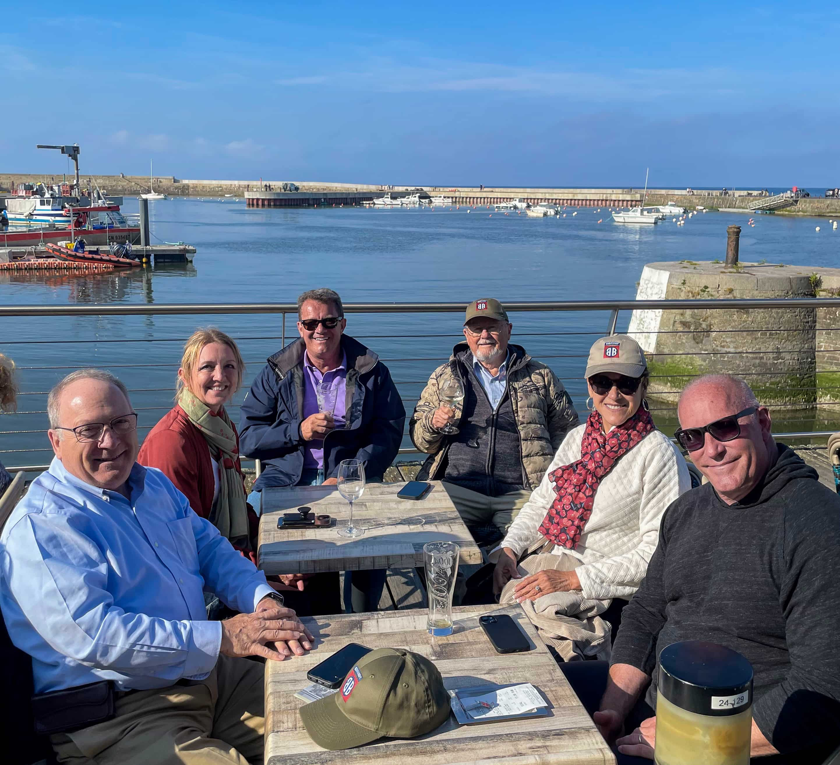 Beyond the Beachhead travelers enjoying drinks at a Normandy fishing harbor