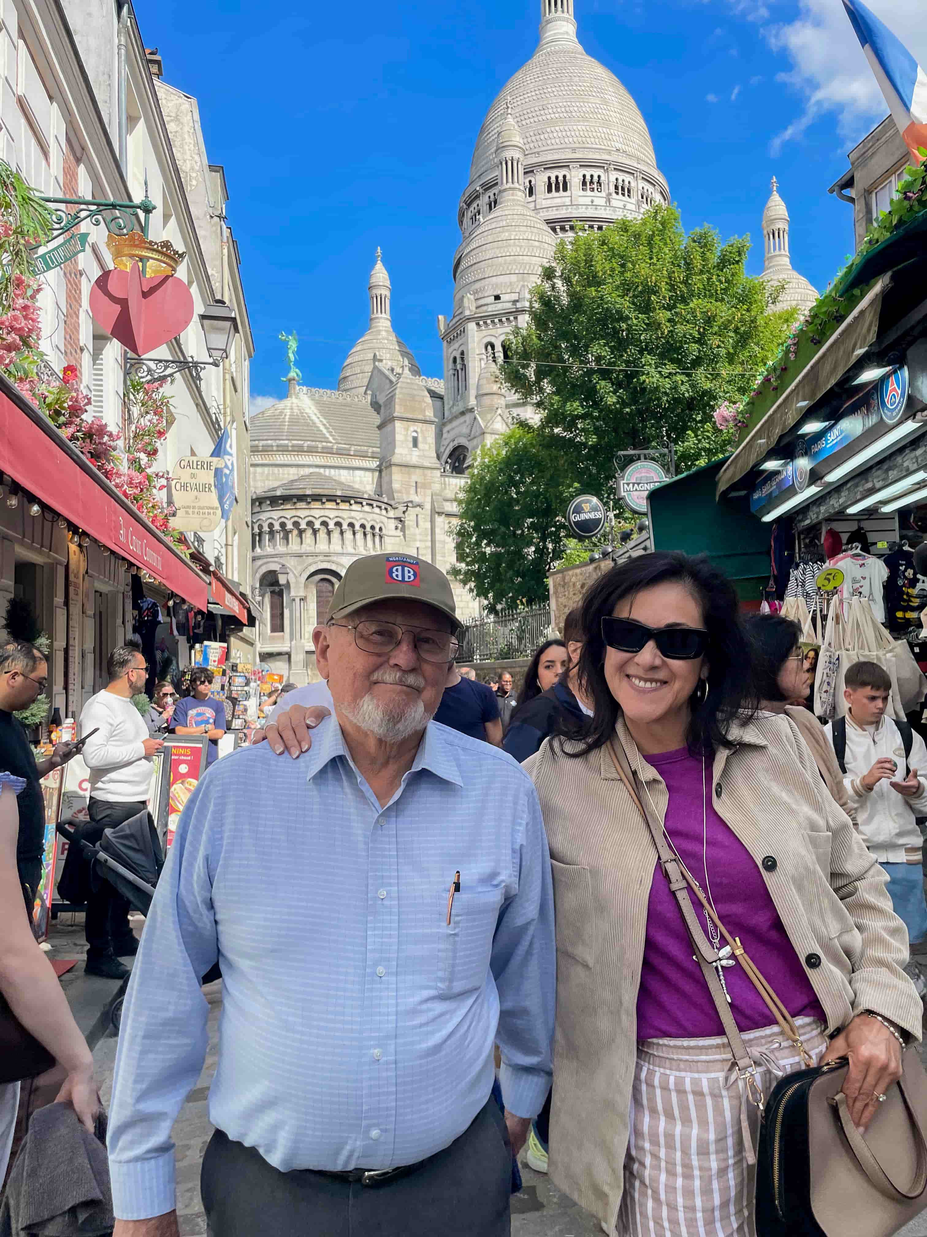 Two travelers in Montmartre below the Sacre-Coeur basilica on the Paris day of the tour