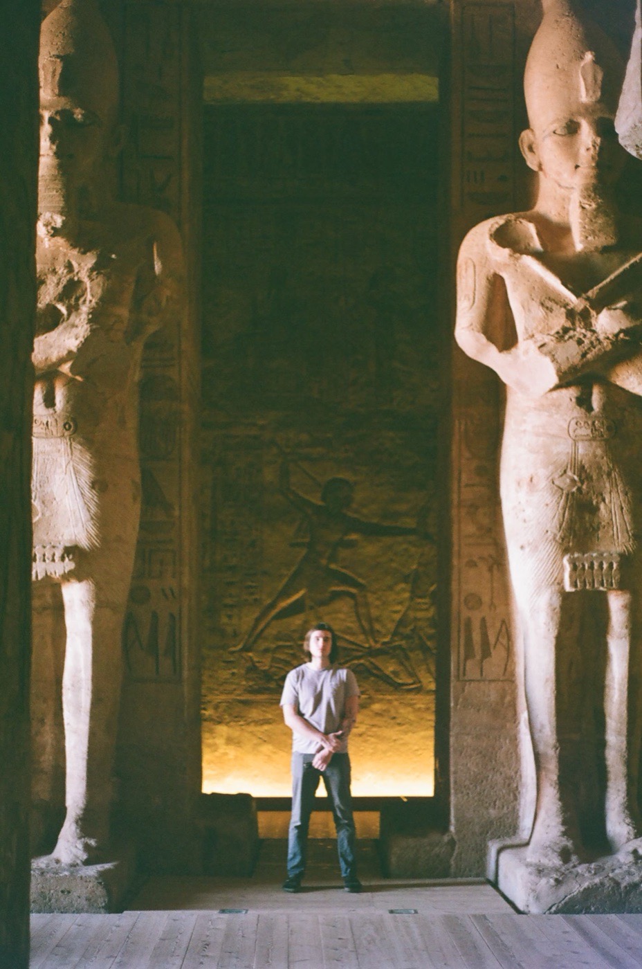 A traveler dwarfed by the statues inside the temple at Abu Simbel