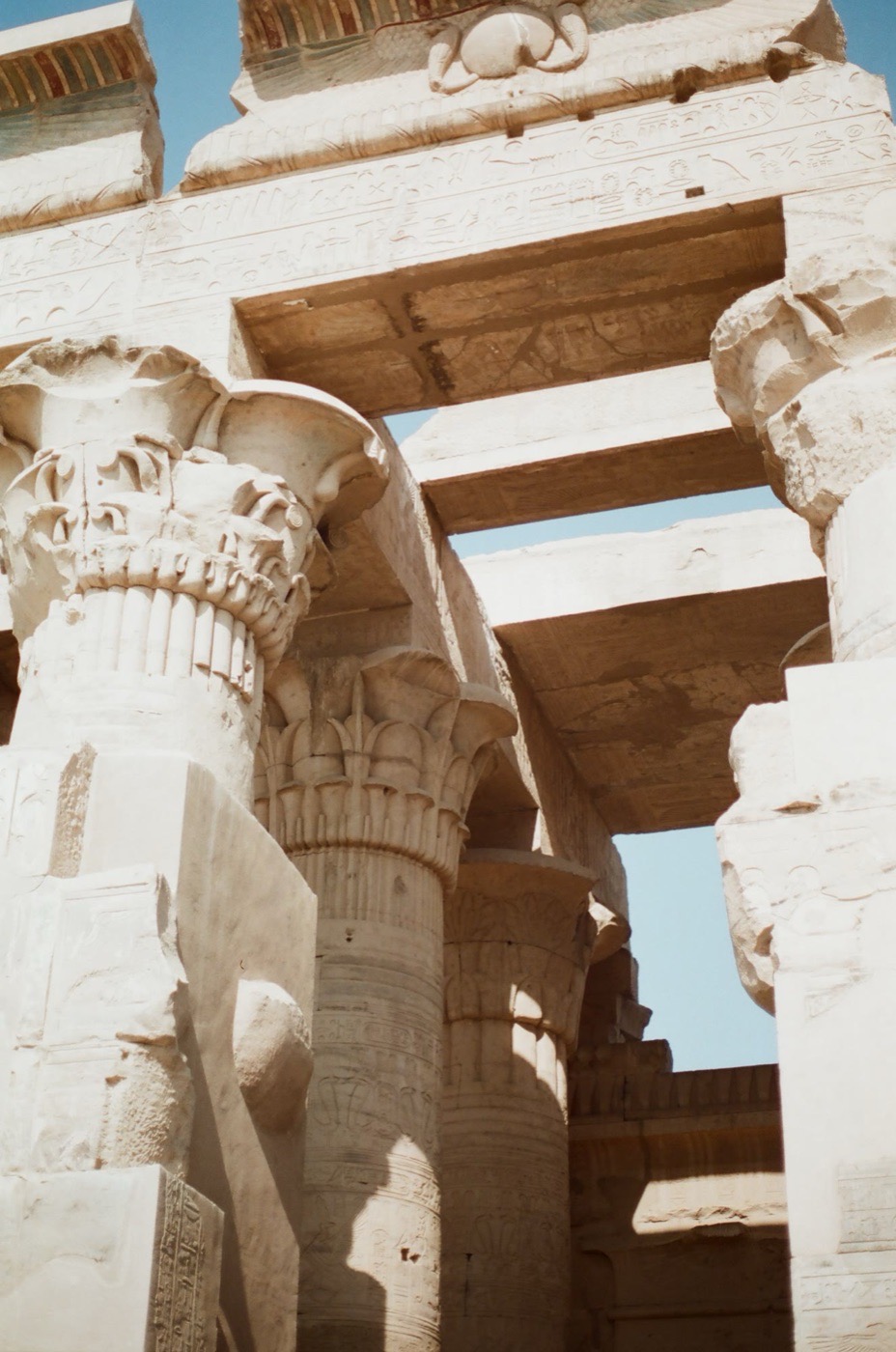Carved capitals and painted ceiling blocks at Kom Ombo