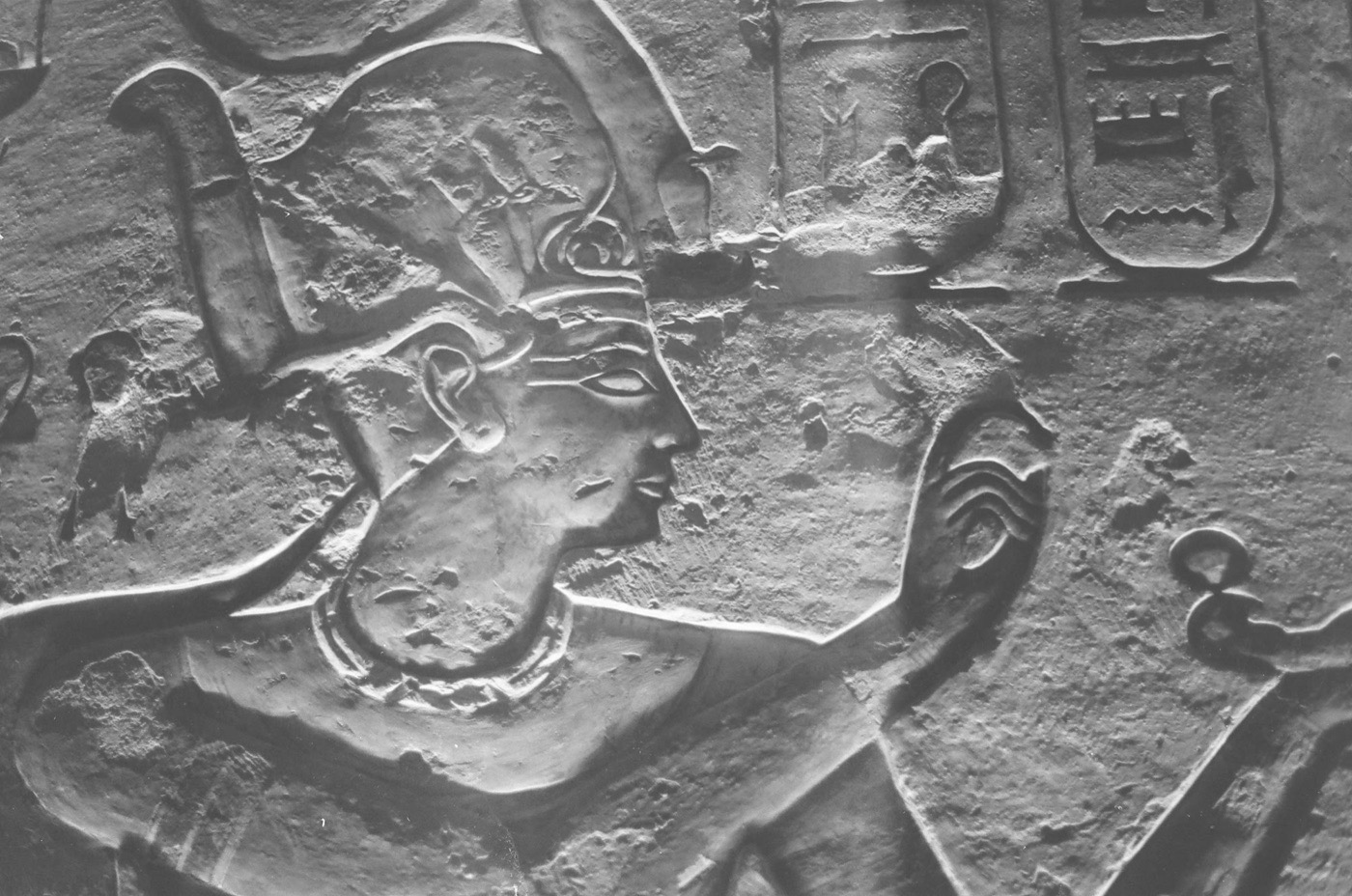 A pharaoh in raised relief, cut sharp by low sun