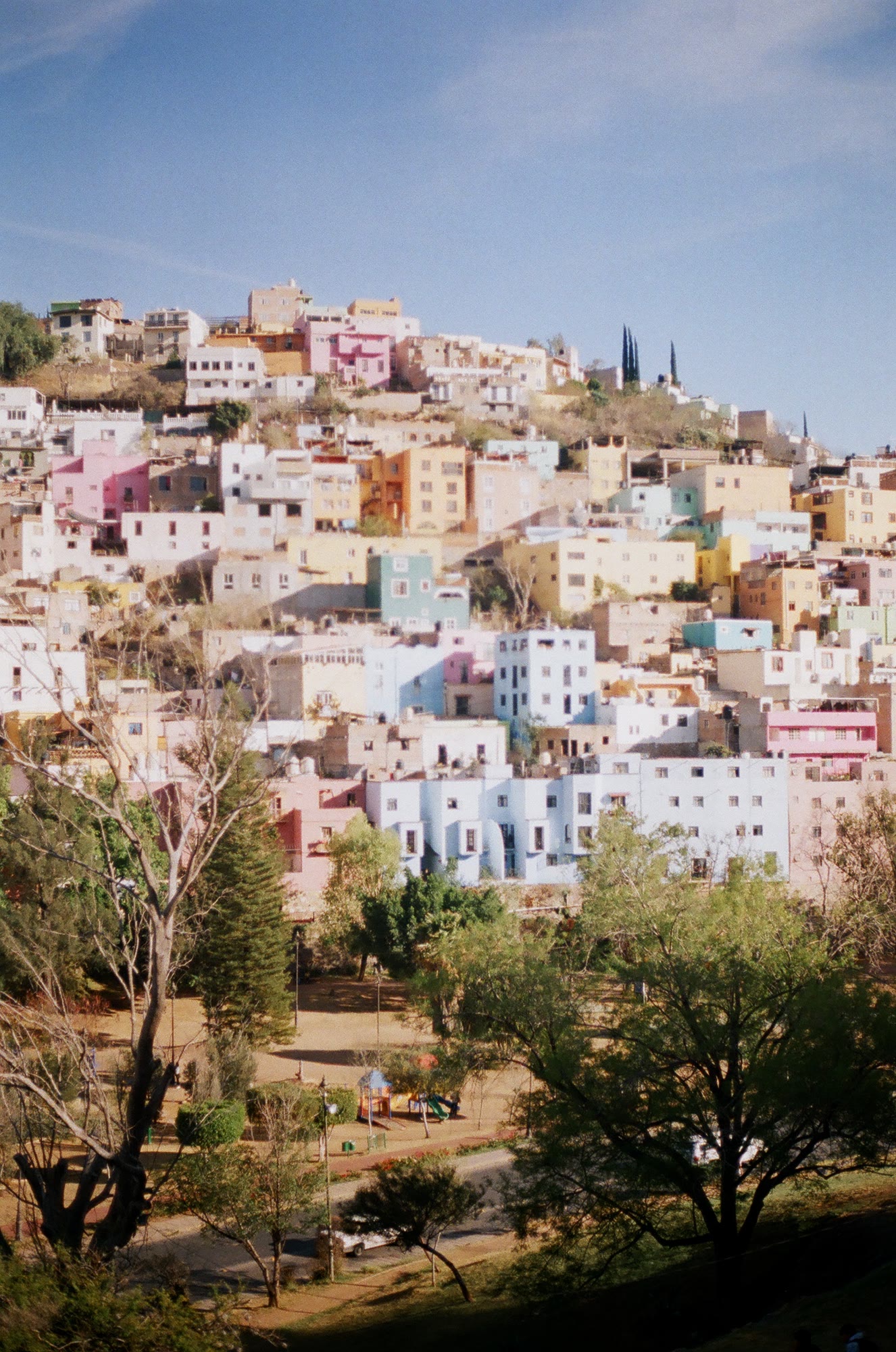 Houses stacked in colour up the hillside above Guanajuato