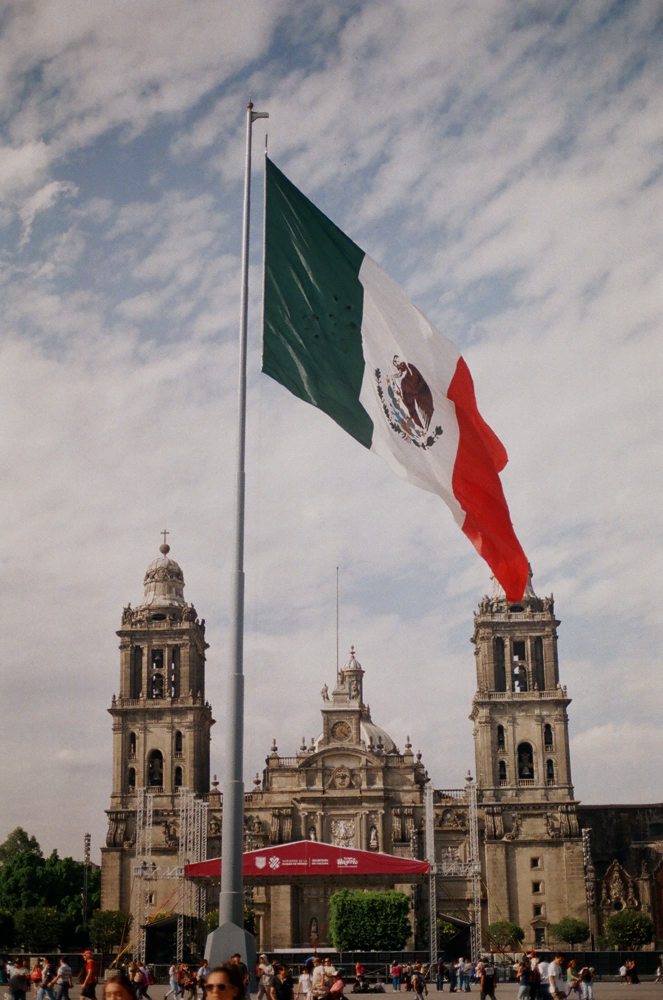 The flag over the Zocalo with the Metropolitan Cathedral behind it