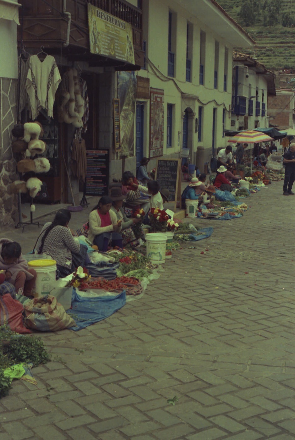 Market sellers with their produce laid out along a Cusco street