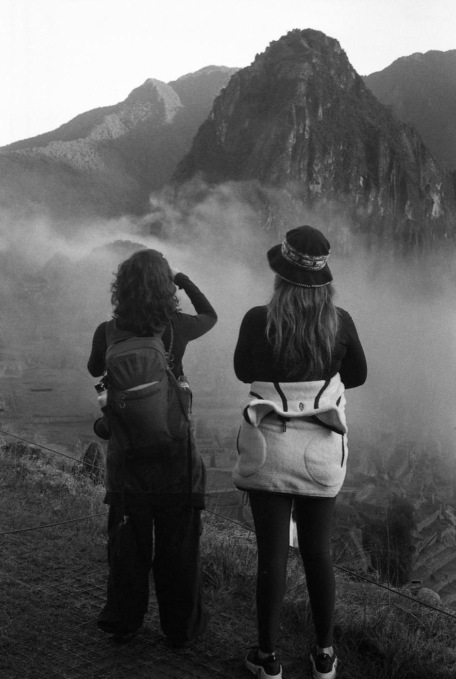 Two travelers taking in their first sight of Machu Picchu