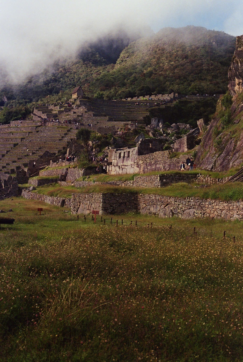 Machu Picchu spread below the ridge, the city in the clouds