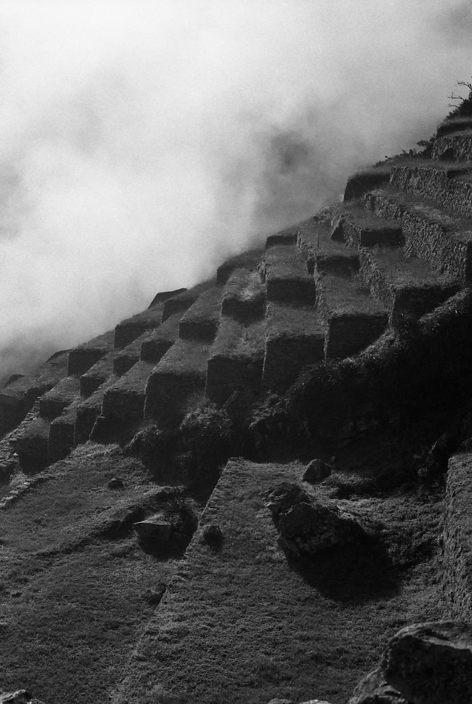 Cloud pouring over the terraces of Machu Picchu