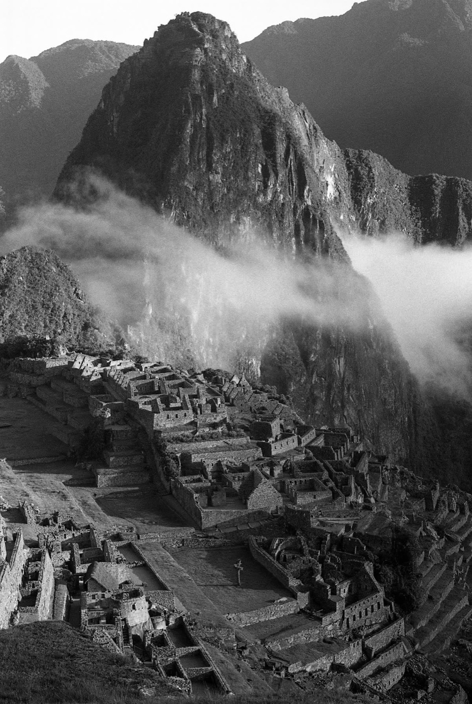The peak above Machu Picchu half lost in cloud