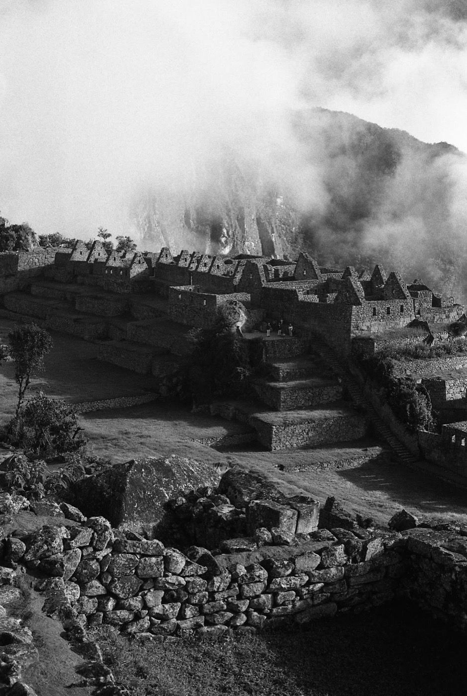 The ruins of Machu Picchu emerging from the mist