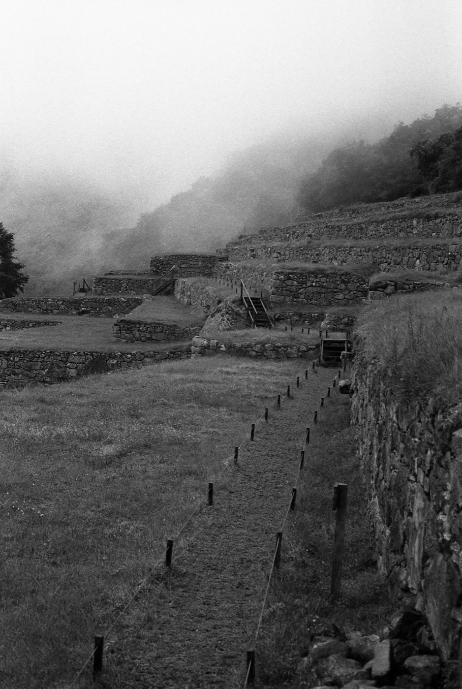 The terraces of Machu Picchu under morning mist