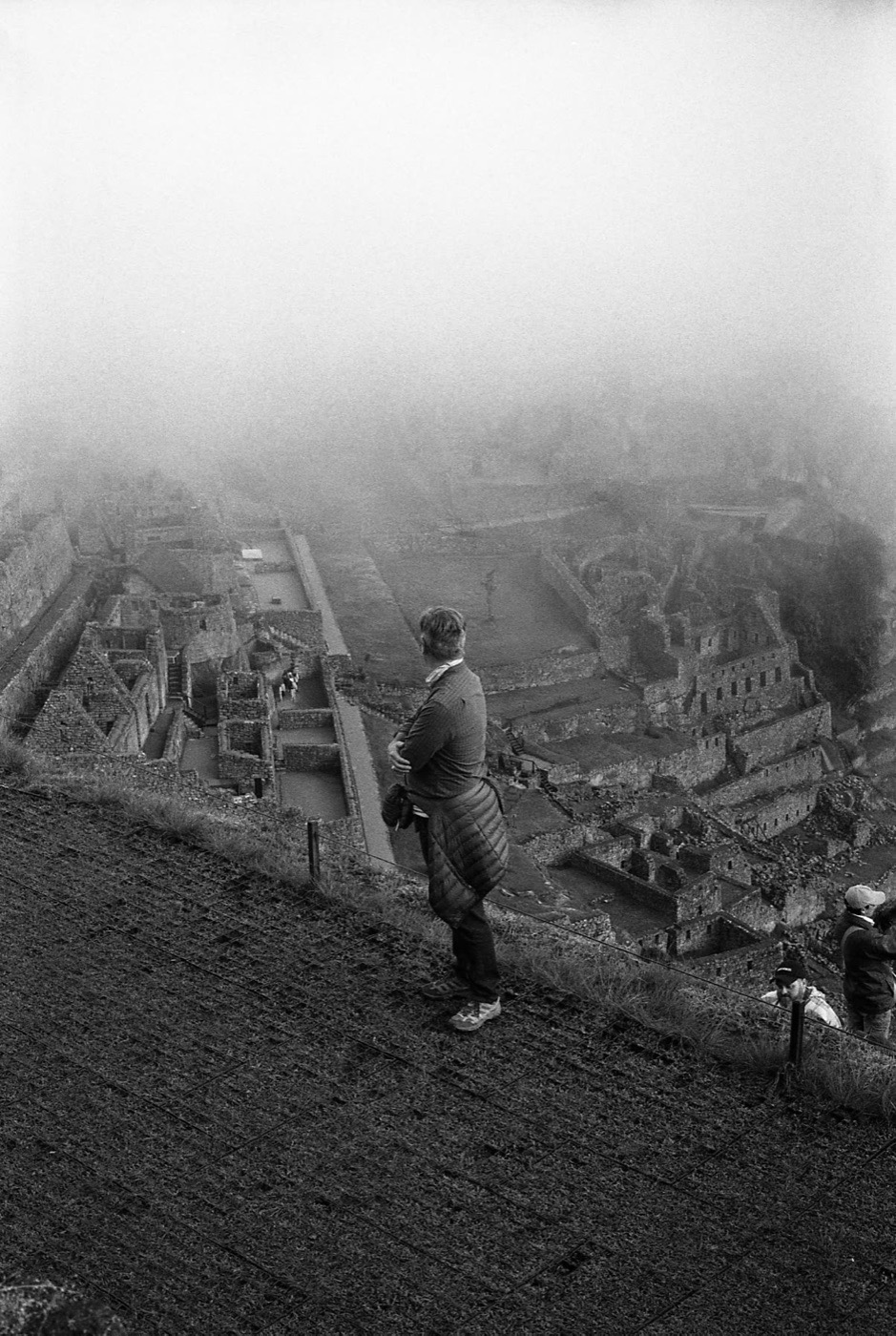 A figure crossing the upper terraces of Machu Picchu