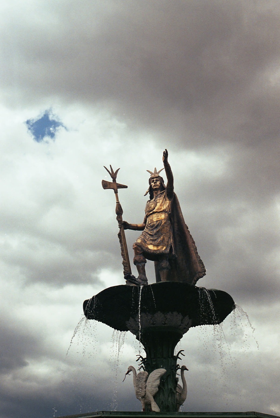 The monument to Pachacuti against a bank of cloud