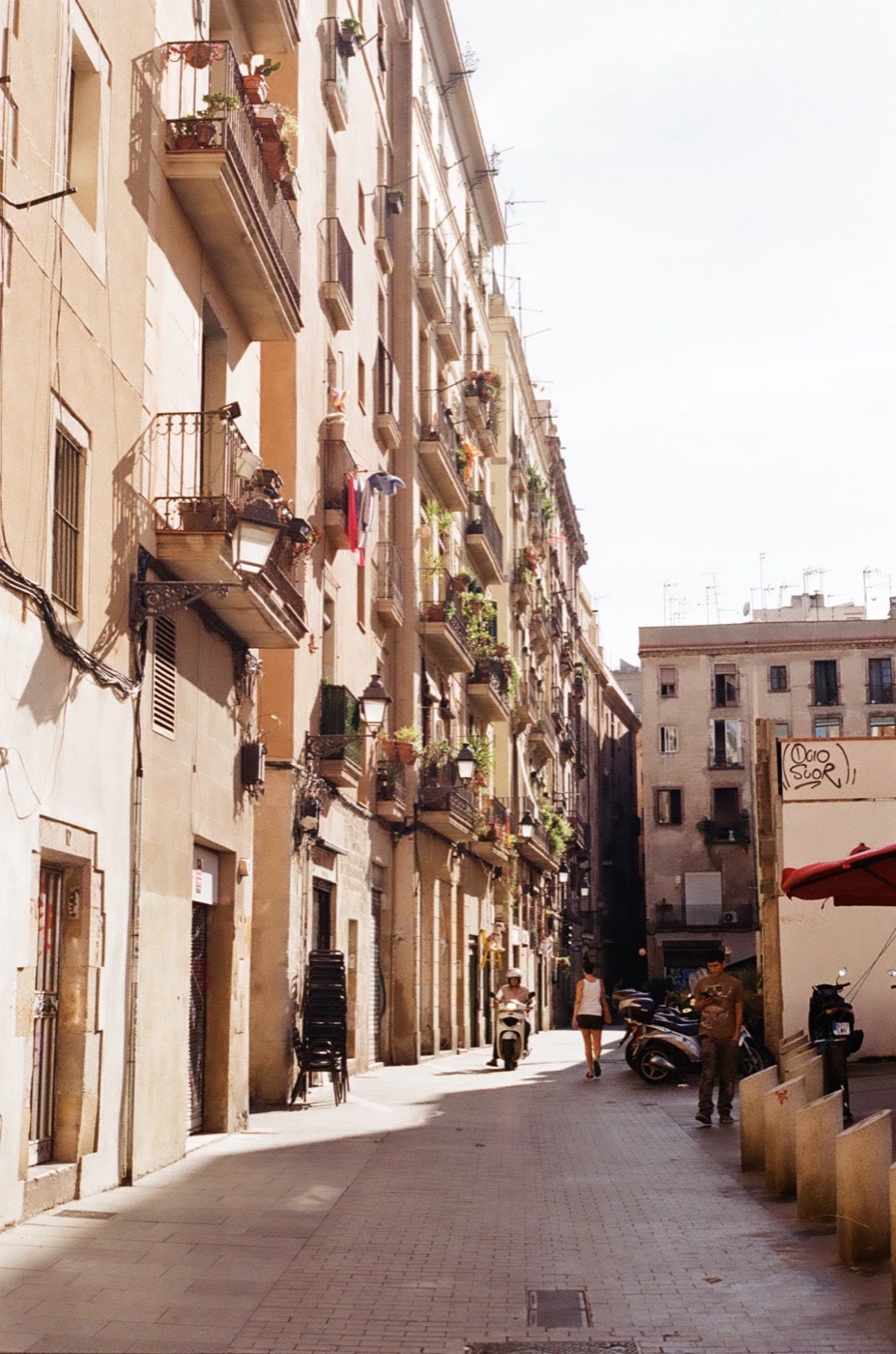 Wrought-iron balconies above a narrow street in Barcelona